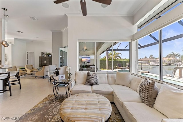 living room with ornamental molding, a water view, and ceiling fan