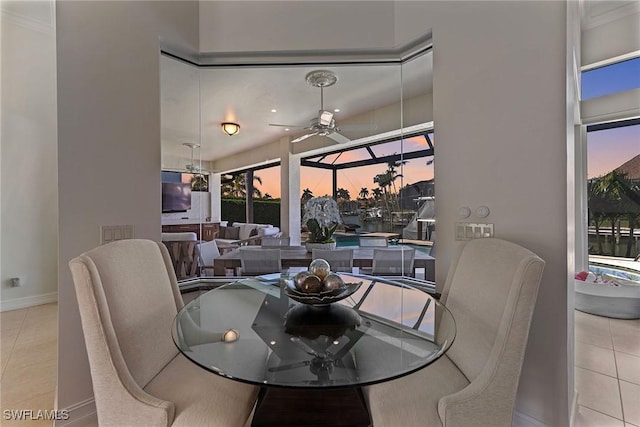 tiled dining space with ceiling fan