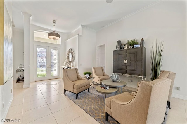 sitting room with crown molding, french doors, and light tile patterned flooring