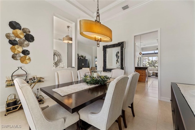dining area featuring light tile patterned floors and crown molding