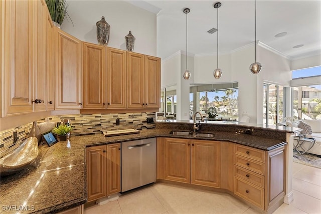 kitchen with sink, crown molding, decorative light fixtures, dark stone countertops, and dishwasher