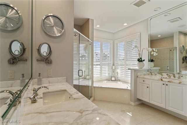 bathroom with plus walk in shower, vanity, and tile patterned floors