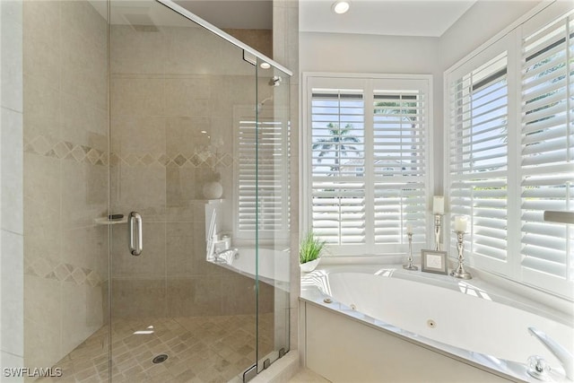 bathroom with shower with separate bathtub