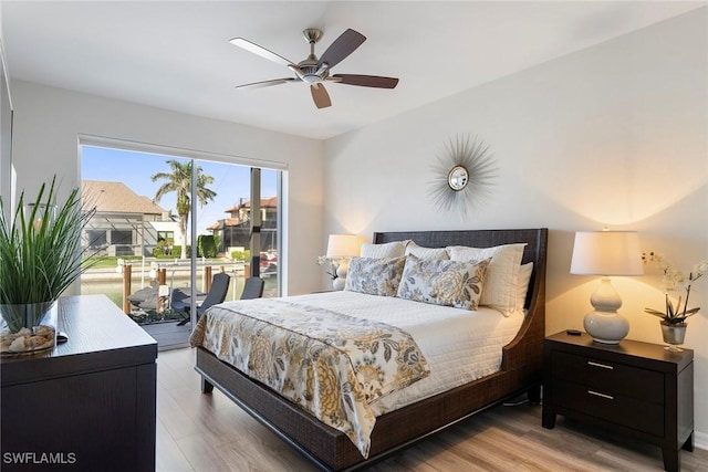 bedroom featuring access to outside, ceiling fan, and light hardwood / wood-style flooring