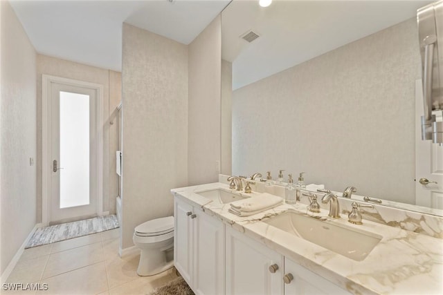 bathroom featuring vanity, toilet, an enclosed shower, and tile patterned flooring