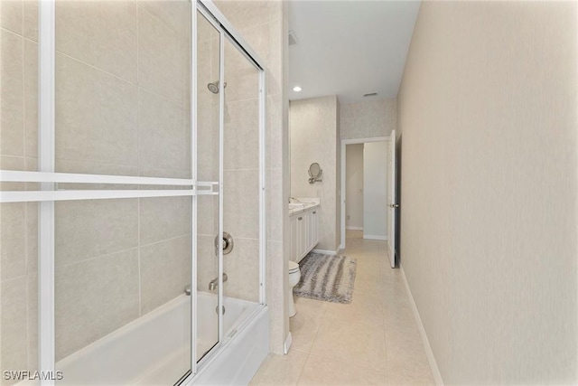 full bathroom featuring vanity, tile patterned flooring, enclosed tub / shower combo, and toilet
