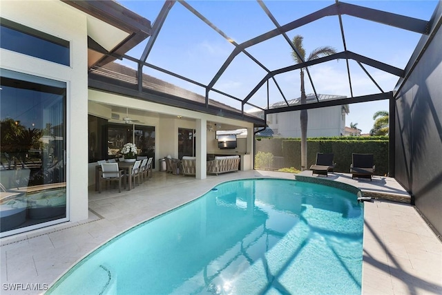 view of swimming pool featuring a patio, a lanai, and an outdoor kitchen