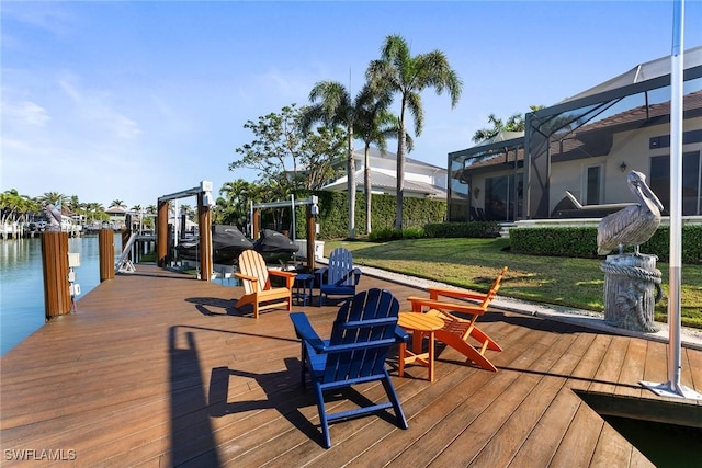 view of dock featuring a water view, a yard, and glass enclosure