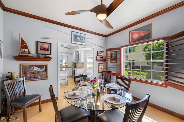 dining space with ceiling fan, a wealth of natural light, and crown molding