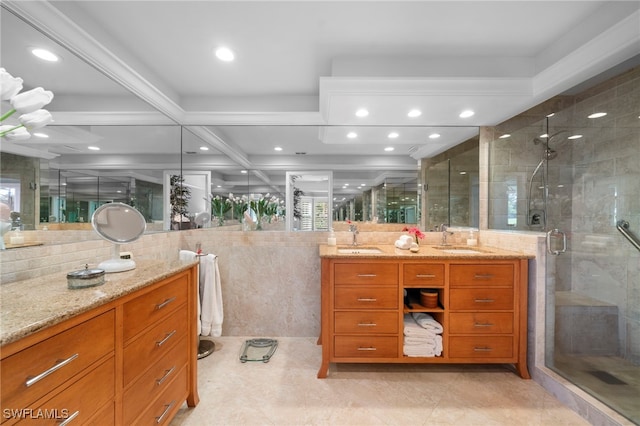 bathroom with a shower with shower door, tile walls, coffered ceiling, beamed ceiling, and vanity