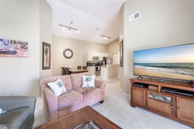 living area featuring light carpet, high vaulted ceiling, and visible vents
