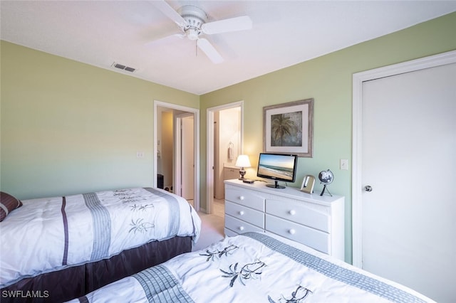 bedroom featuring light colored carpet, visible vents, and ceiling fan