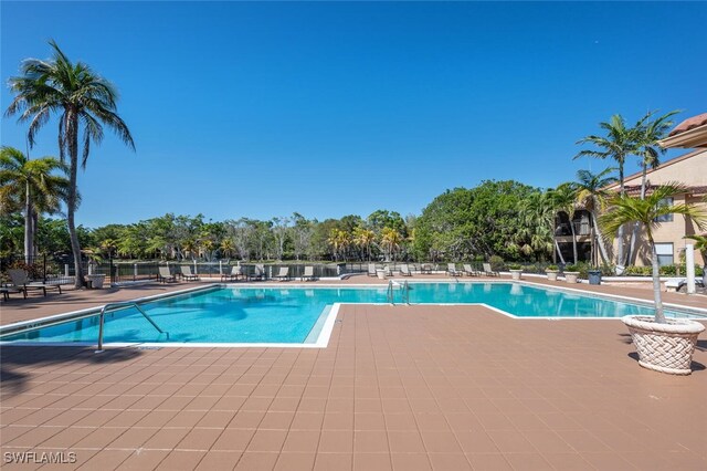 pool with fence and a patio area