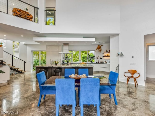 dining room with a towering ceiling