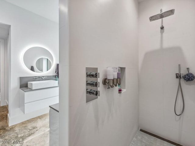 bathroom with a shower and vanity