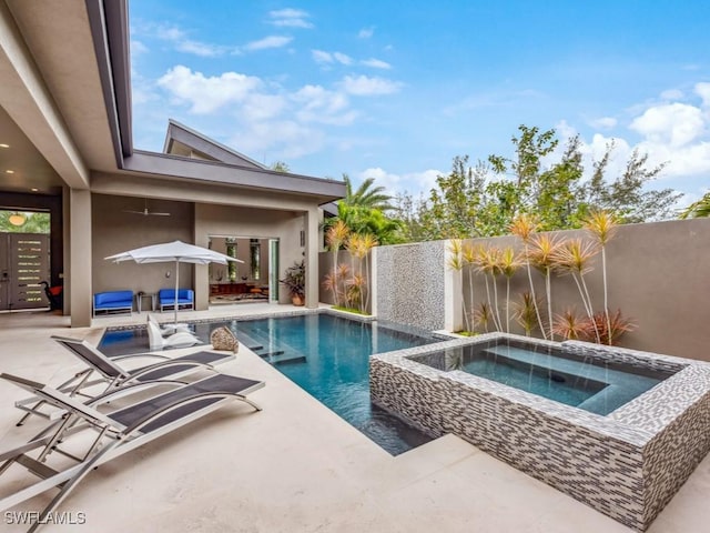 view of pool featuring a patio area and an in ground hot tub