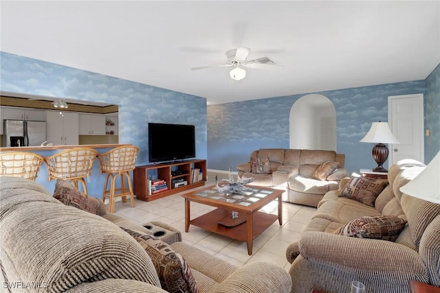 tiled living room featuring ceiling fan