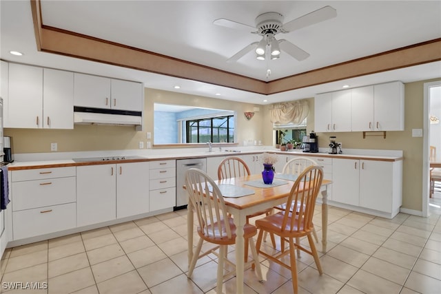 kitchen with white cabinetry, stainless steel dishwasher, black electric cooktop, and a raised ceiling