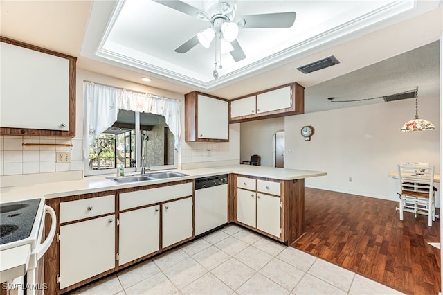 kitchen with hanging light fixtures, stainless steel dishwasher, kitchen peninsula, white cabinets, and white range with electric stovetop