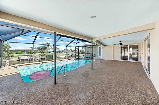 view of pool with a water view, a patio, ceiling fan, and glass enclosure