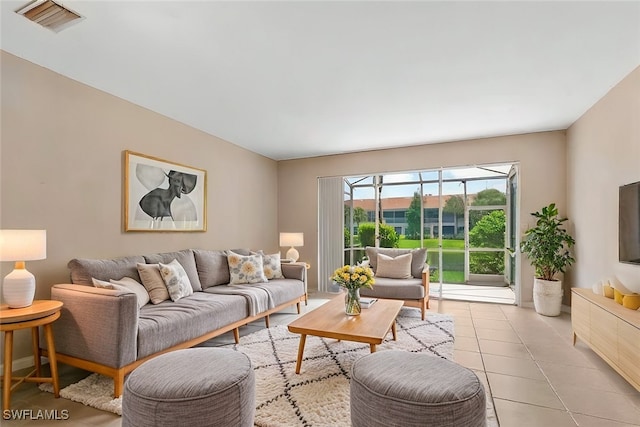 living area with visible vents and light tile patterned floors