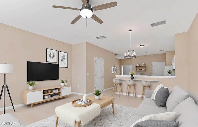 1172 Oxford Ln Unit 27, Naples, FL 34105 - living room with baseboards, visible vents, and ceiling fan with notable chandelier