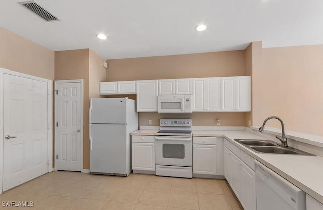 1172 Oxford Ln Unit 27, Naples, FL 34105 - kitchen featuring light countertops, visible vents, white cabinets, a sink, and white appliances