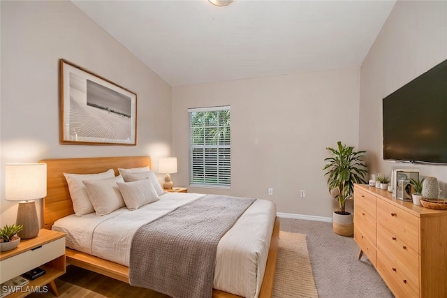 1172 Oxford Ln Unit 27, Naples, FL 34105 - bedroom with lofted ceiling, carpet, and baseboards