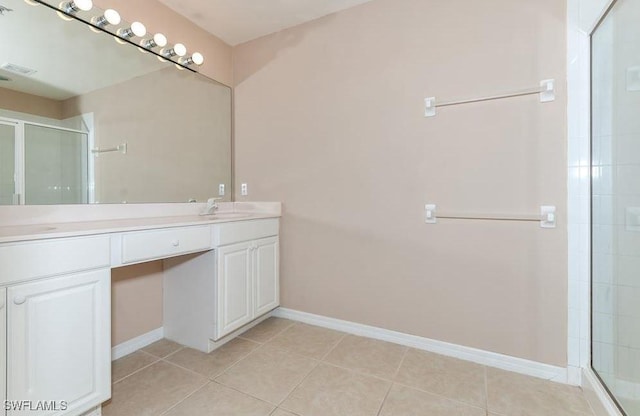 1172 Oxford Ln Unit 27, Naples, FL 34105 - full bathroom featuring tile patterned flooring, a shower stall, baseboards, and double vanity