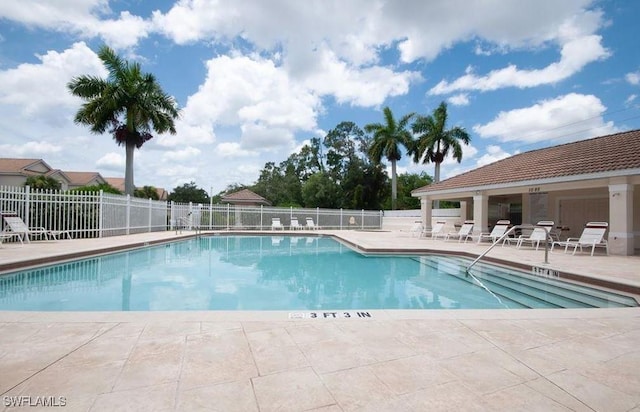 1172 Oxford Ln Unit 27, Naples, FL 34105 - community pool featuring a patio area and fence