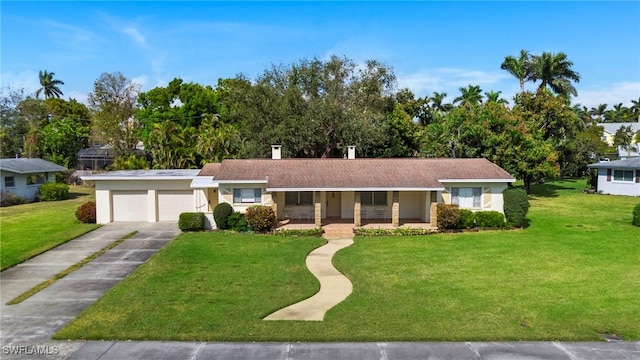 ranch-style house with covered porch, a front yard, and a garage