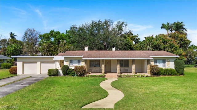 single story home featuring a porch, a front lawn, and a garage