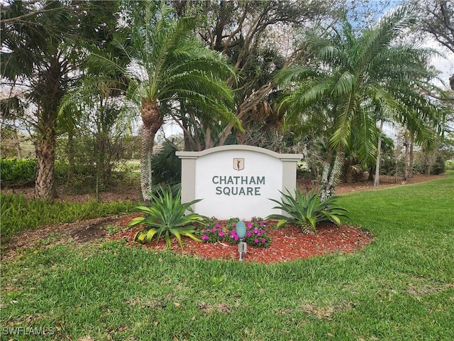 community / neighborhood sign with a yard