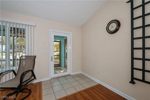 4001 E Sunflower Cir, Labelle, FL 33935 - entryway with light tile patterned floors, baseboards, and lofted ceiling