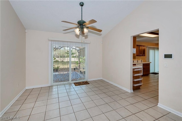 4001 E Sunflower Cir, Labelle, FL 33935 - unfurnished room featuring light tile patterned floors, baseboards, vaulted ceiling, and ceiling fan