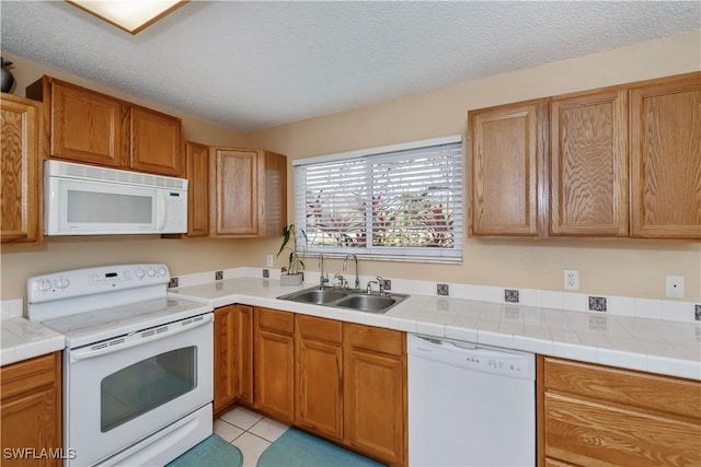 4001 E Sunflower Cir, Labelle, FL 33935 - kitchen featuring a textured ceiling, a sink, light tile patterned floors, and white appliances