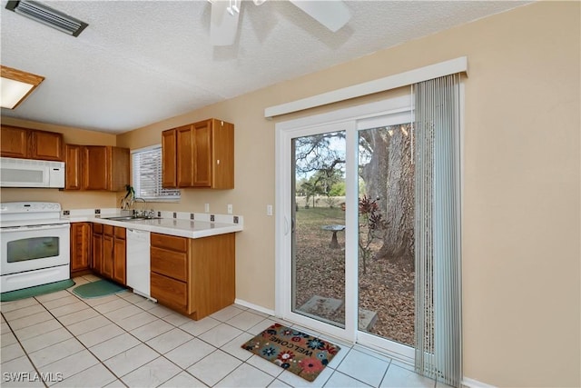 4001 E Sunflower Cir, Labelle, FL 33935 - kitchen with light countertops, a healthy amount of sunlight, white appliances, a sink, and visible vents