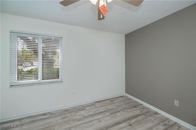 4001 E Sunflower Cir, Labelle, FL 33935 - unfurnished room featuring a textured ceiling, baseboards, ceiling fan, and wood finished floors