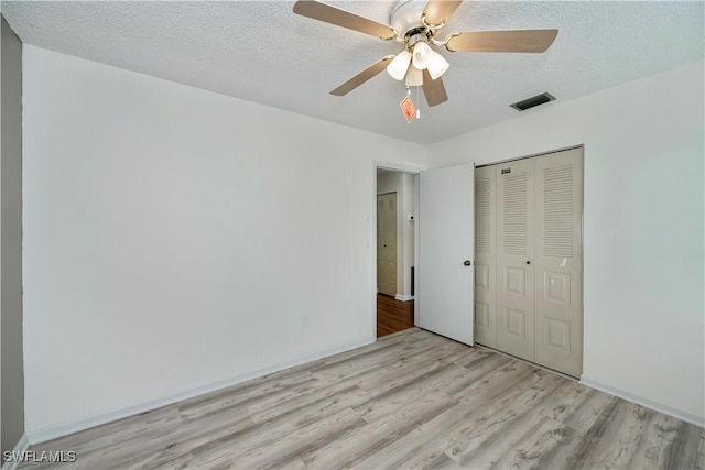 4001 E Sunflower Cir, Labelle, FL 33935 - unfurnished bedroom with visible vents, a closet, wood finished floors, and a textured ceiling