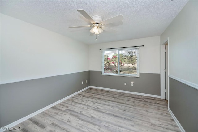 4001 E Sunflower Cir, Labelle, FL 33935 - spare room with a textured ceiling, baseboards, ceiling fan, and wood finished floors
