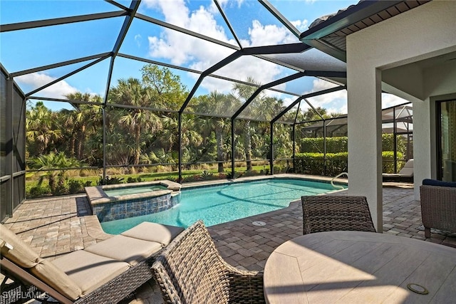 view of swimming pool with an in ground hot tub, a lanai, and a patio