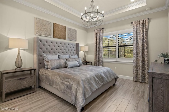 bedroom featuring an inviting chandelier, crown molding, a raised ceiling, and light wood-type flooring