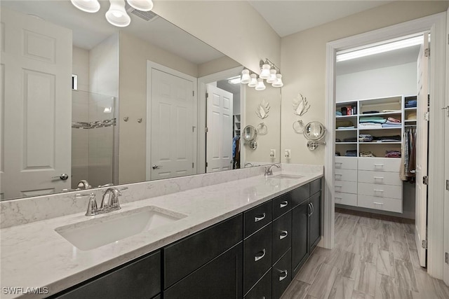 bathroom with vanity and an enclosed shower