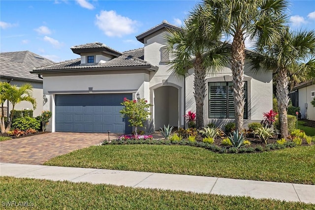 mediterranean / spanish home with a garage and a front yard