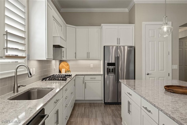 kitchen with light stone countertops, appliances with stainless steel finishes, sink, and white cabinets