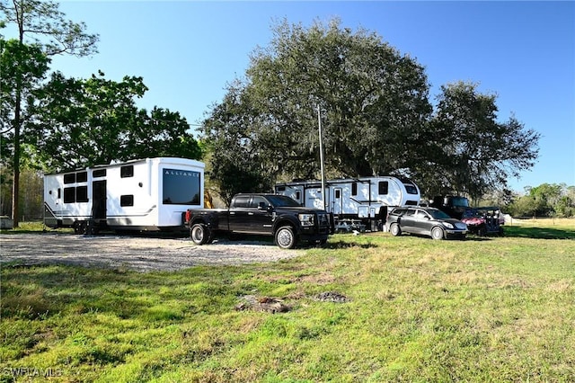 view of car parking with a lawn