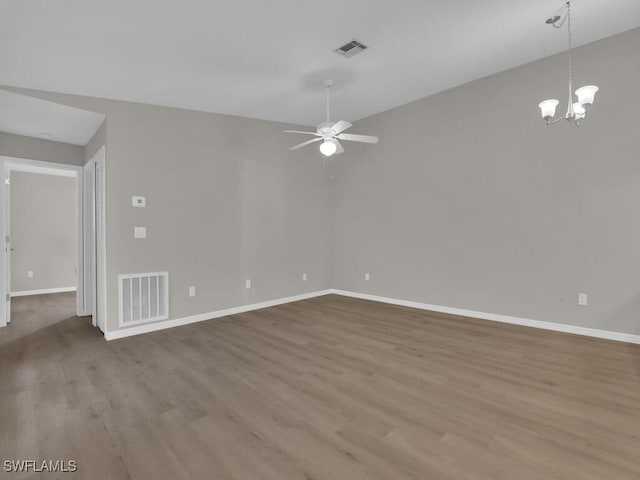 unfurnished room with visible vents, baseboards, and wood finished floors