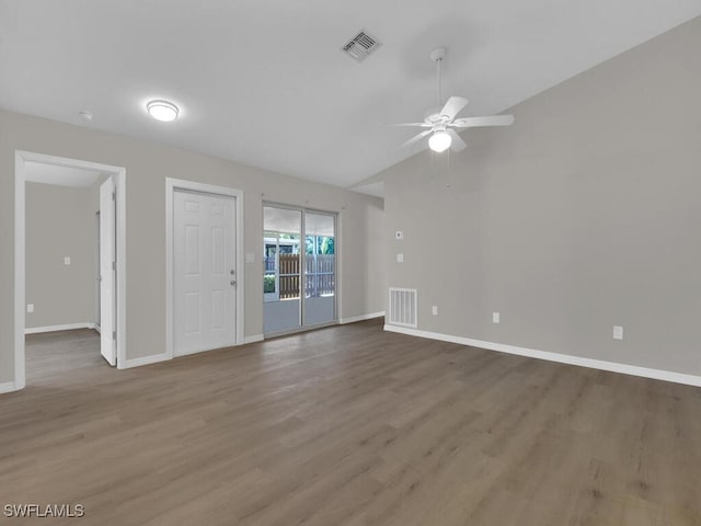 unfurnished room featuring visible vents, baseboards, and wood finished floors