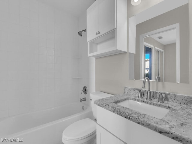 bathroom featuring toilet, vanity, visible vents, and bathing tub / shower combination