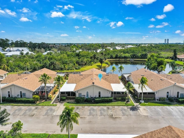 drone / aerial view featuring a residential view and a water view